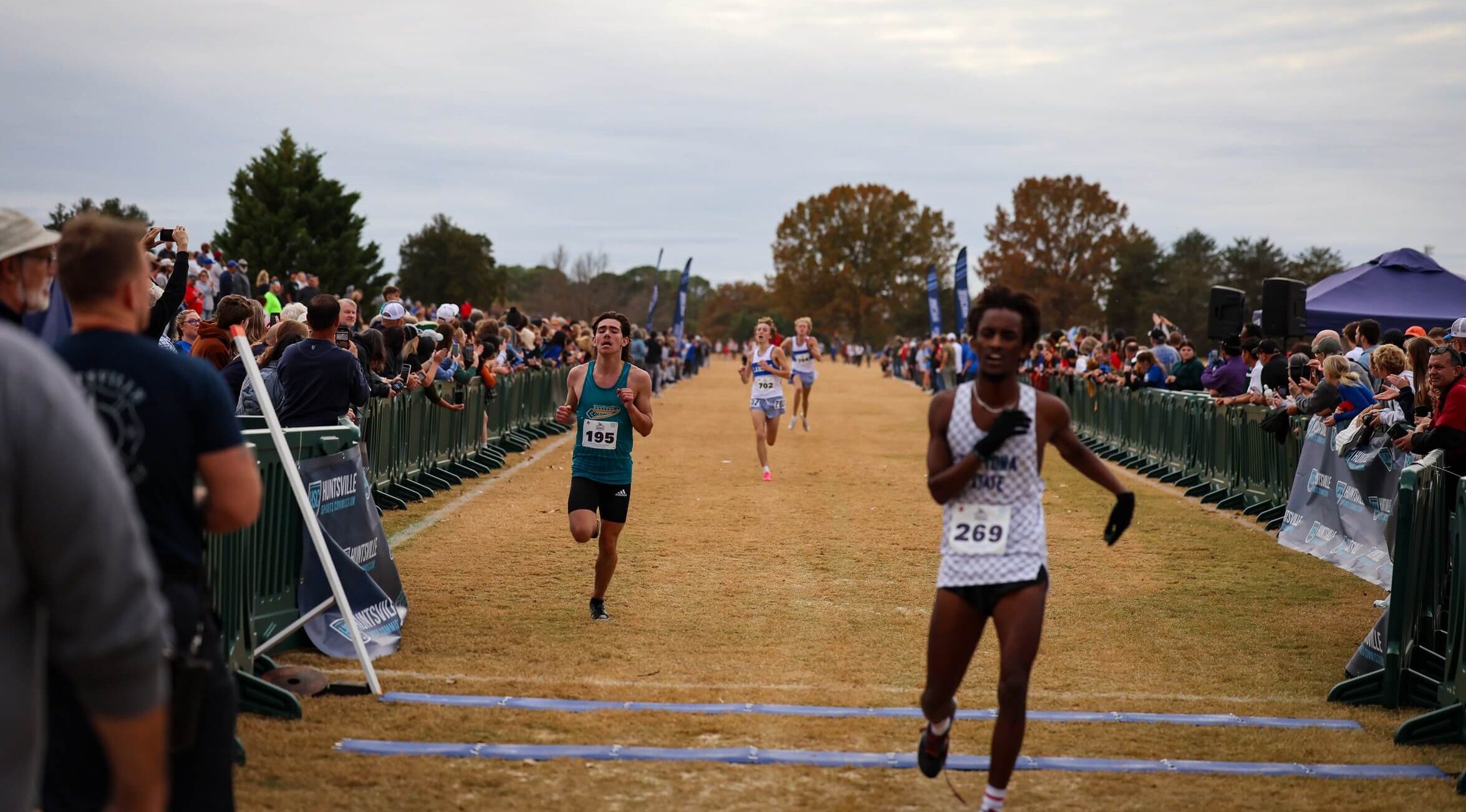 Runners crossing the finish line of the 2023 NJCAA Cross Country National Championships.