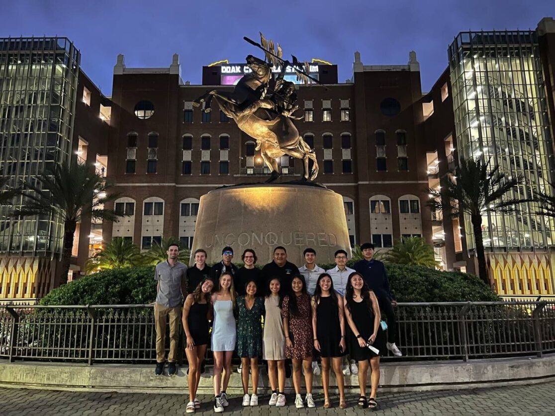 CCC's men's and women's cross country teams posing together in formal wear.