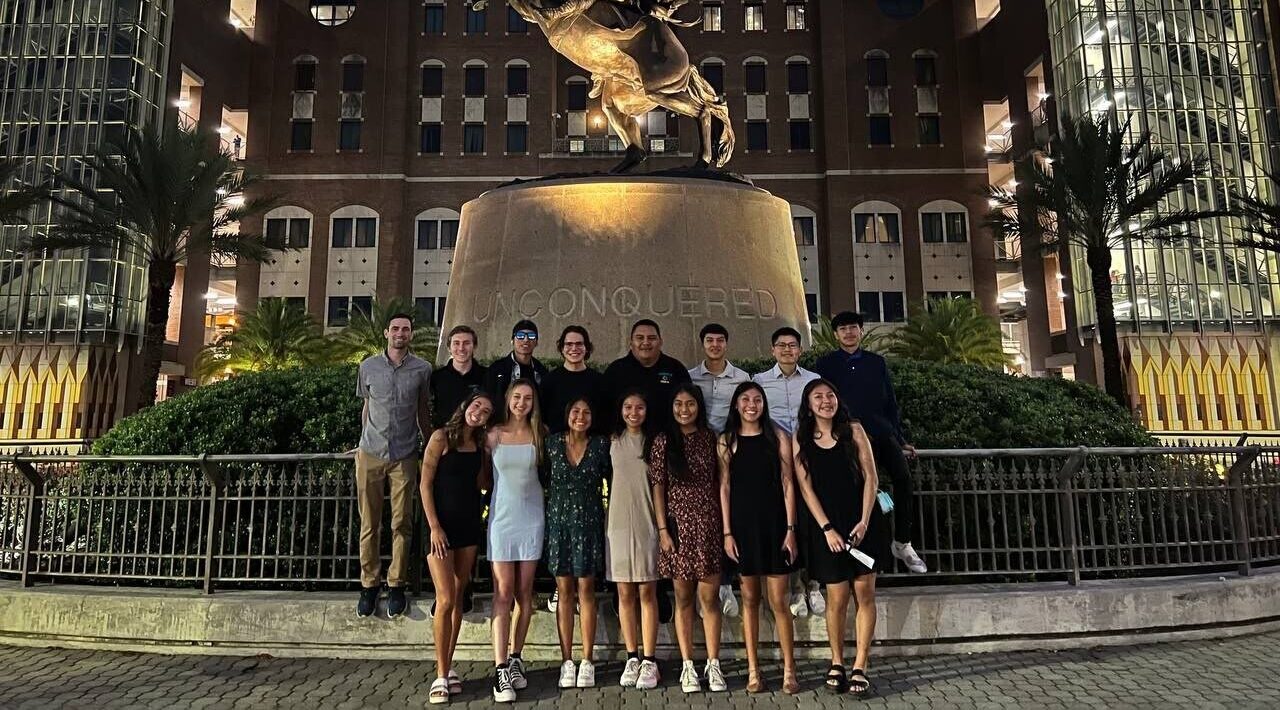CCC's men's and women's cross country teams posing together in formal wear.