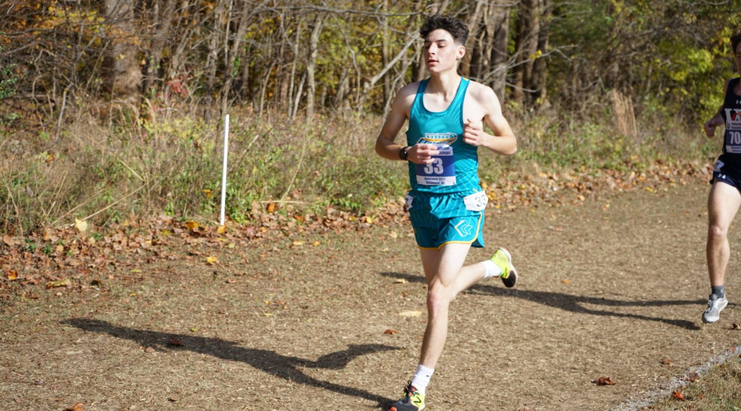 CCC runner racing down a grass path.
