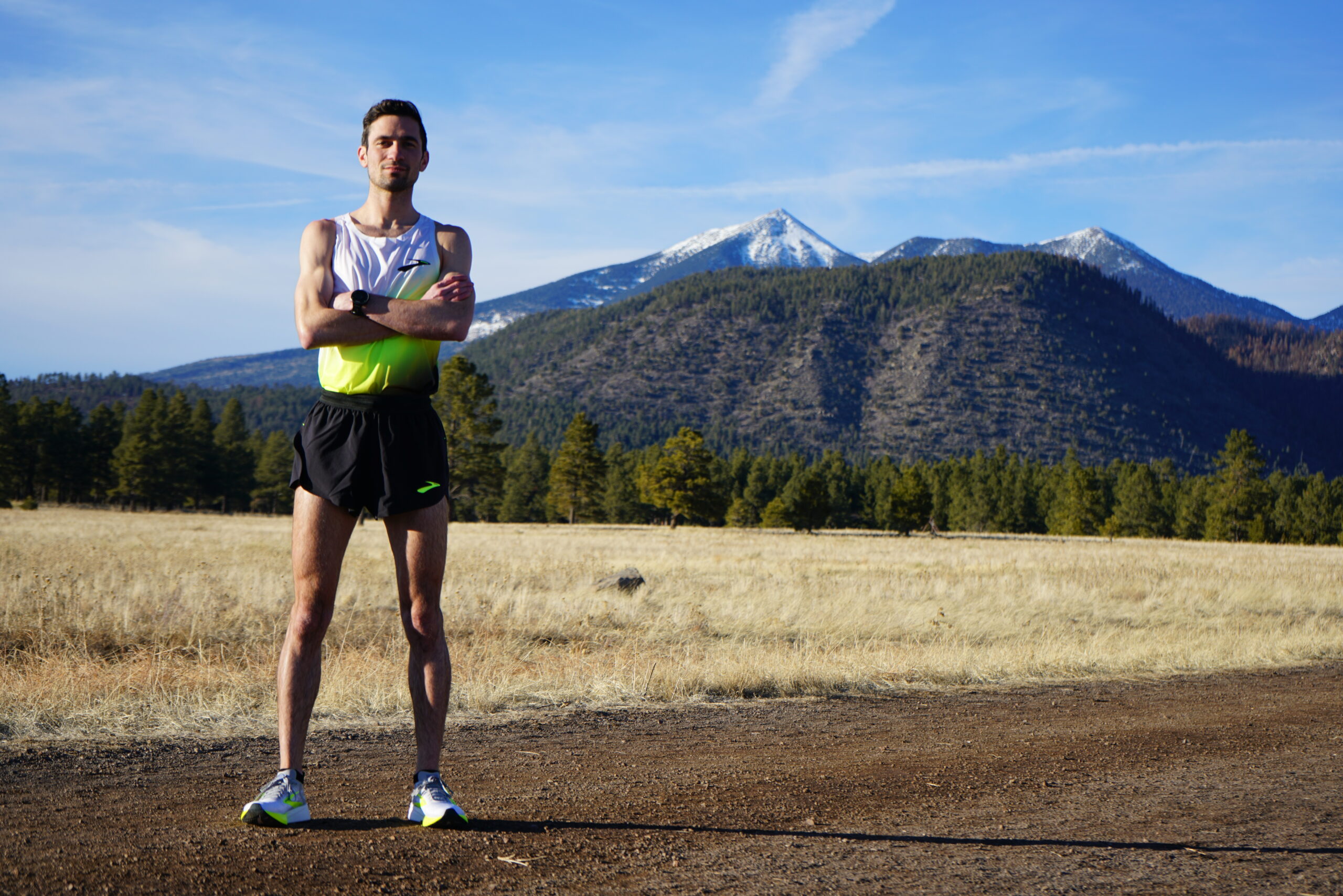 Runner posing with a mountain in the background.