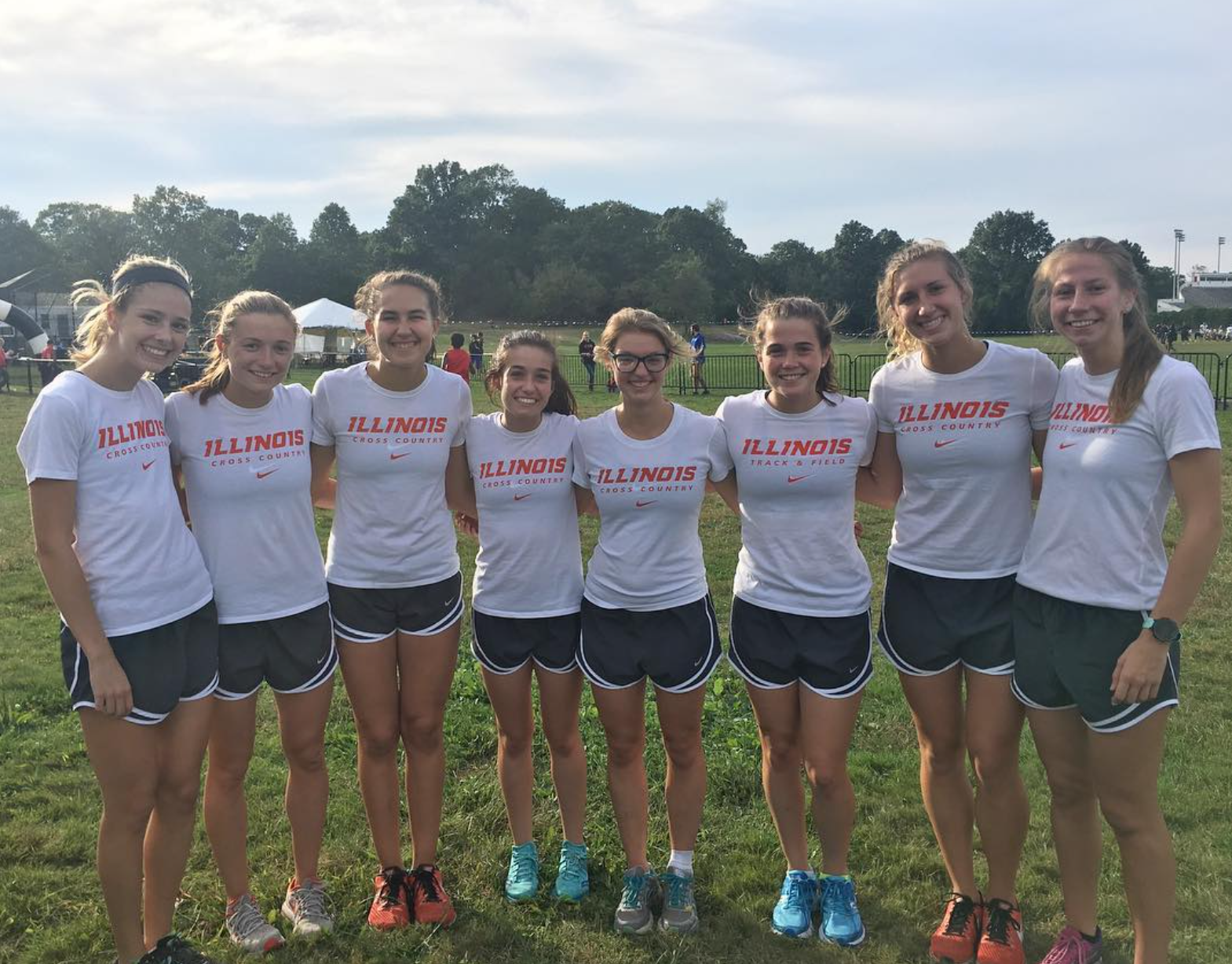 Women's cross country team posing together.