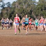 A large pack of women racing cross country with CCC's Hayley Burns leading the way.