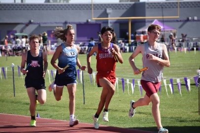 Four male athletes racing on a track