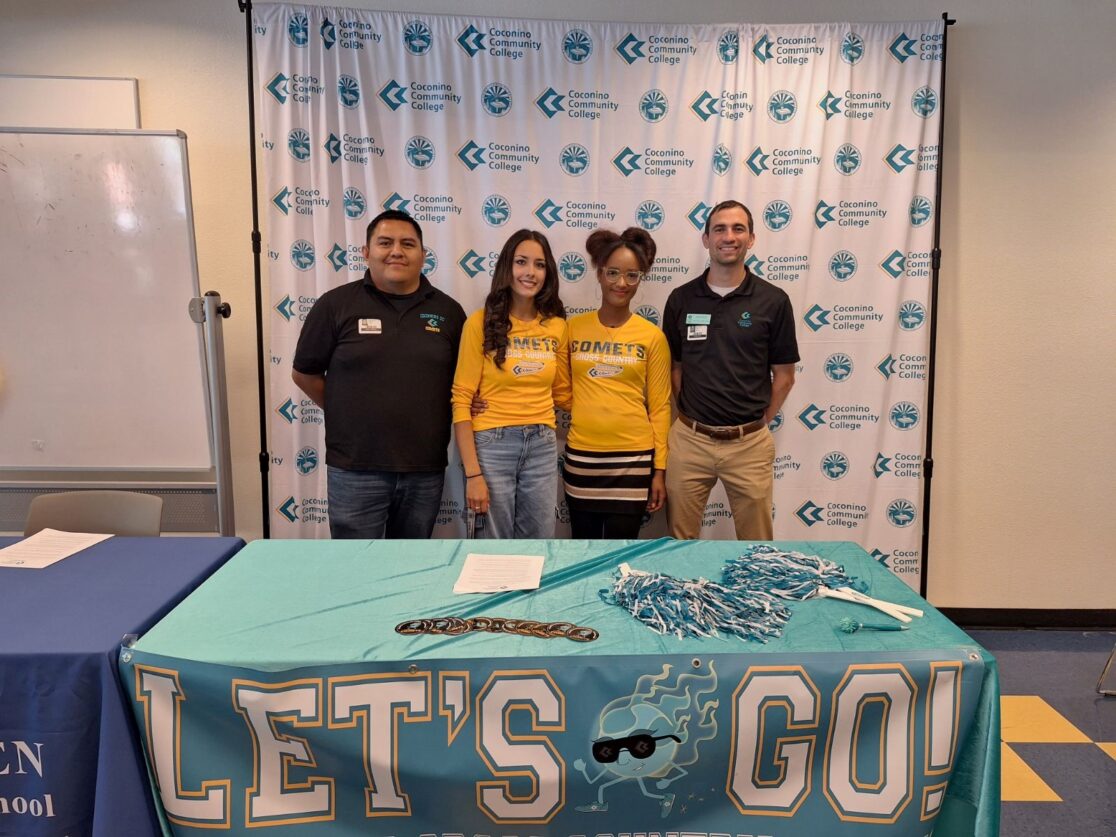 two athletes and two coaches pose for a photo