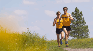 Two college cross country runners racing.
