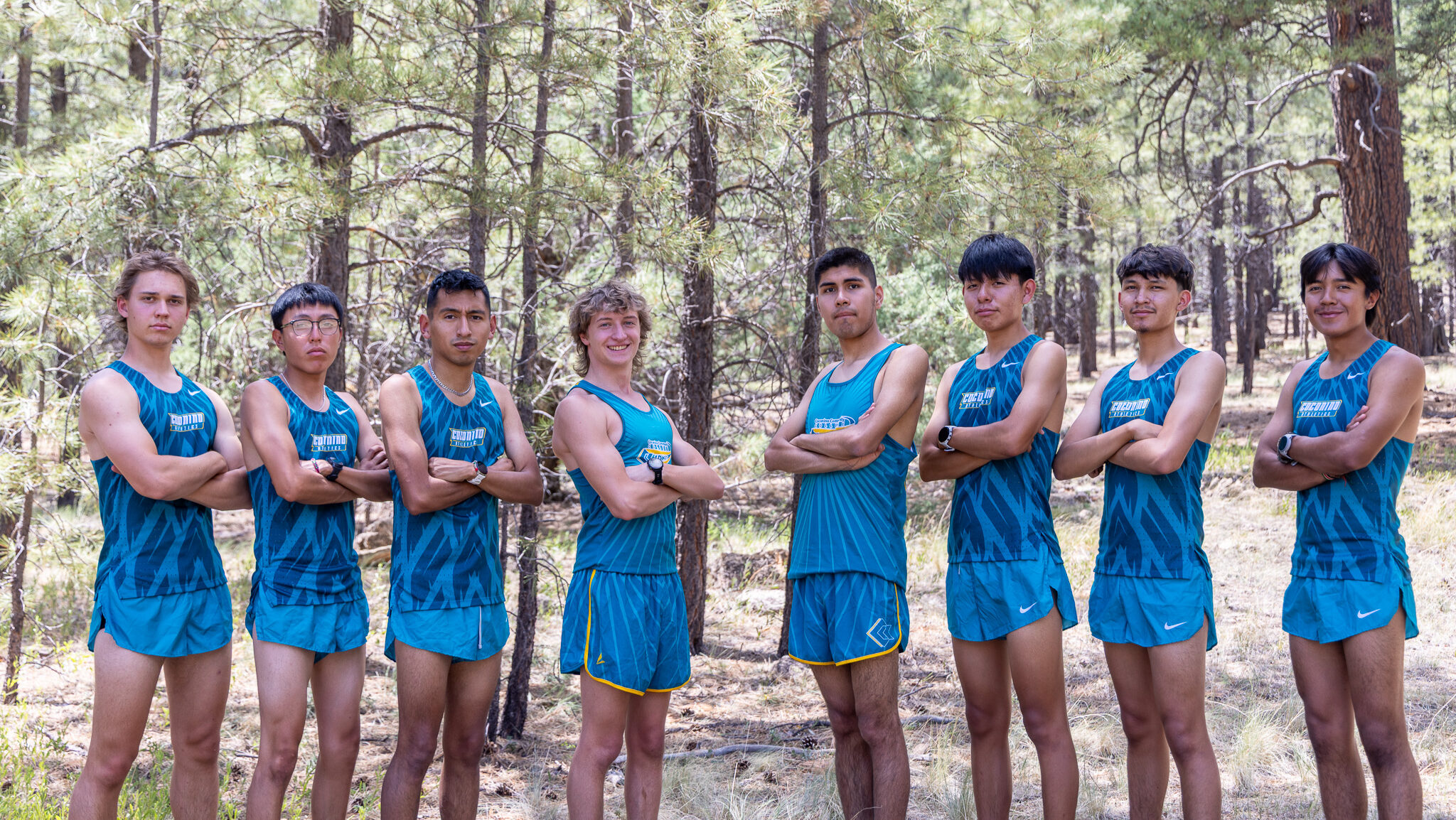 Men's Cross Country team poses for a team photo in uniform